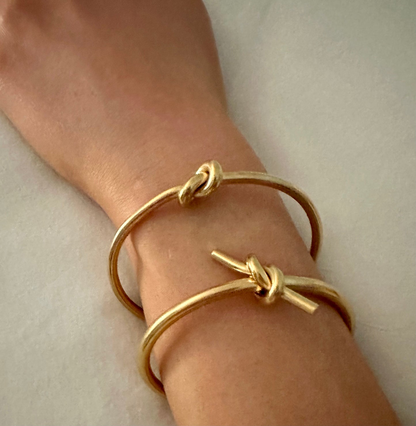 Scarlett Knot Bracelet- Our Scarlett Knot is Stainless Steel with 18K Overlay. Scarlett has a little edge to her and pairs great with our Love Knot Bracelet. C-shaped opening for easy on and off.