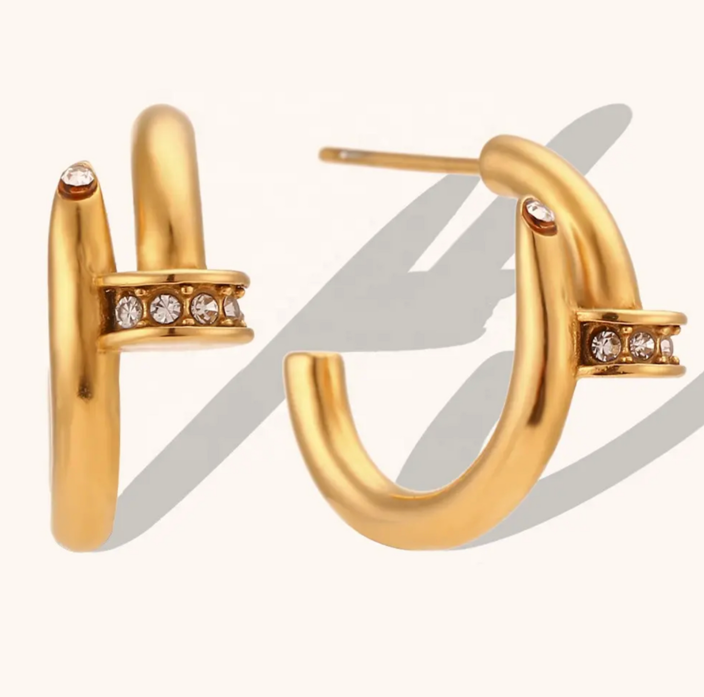 Nadia - Our Nadia is an elegant classic with a twist. Made to look like a nail head with delicate pave stones going through the ear.