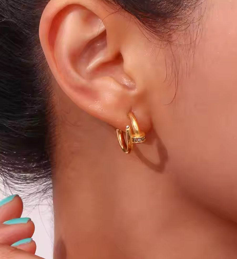Nadia - Our Nadia is an elegant classic with a twist. Made to look like a nail head with delicate pave stones going through the ear.