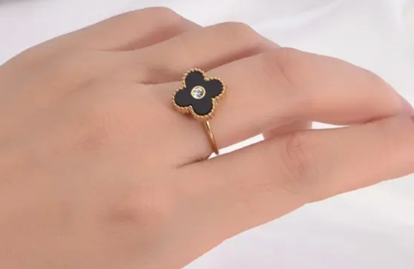 Chloe - Our Chloe ring exudes timeless elegance with its delicate clover design. Crafted of durable SS coated in 18K Gold for a water resistant, tarnish free finish. The adjustable band is one size fits all.
