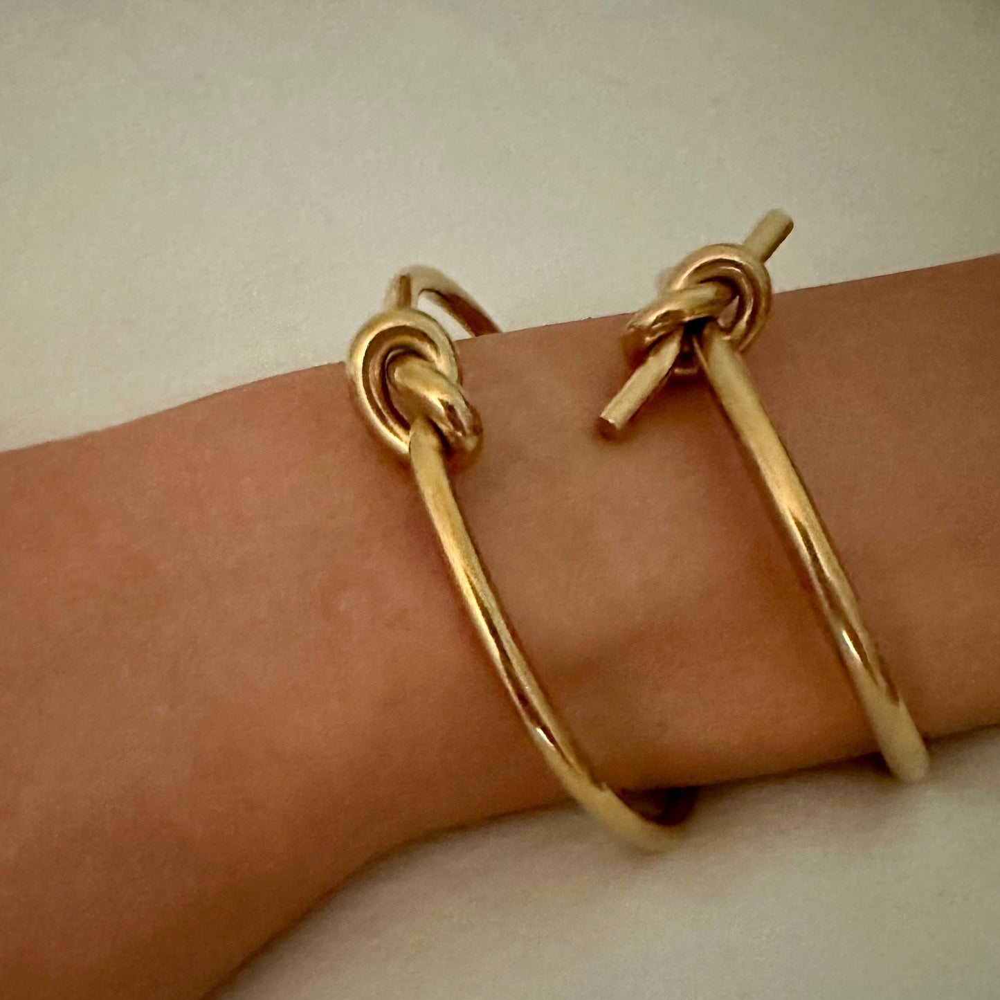 Love Knot Bracelet - Our Love Knot is Crafted Stainless Steel with 18K Gold Overlay Non-Tarnish C-shaped Opening.