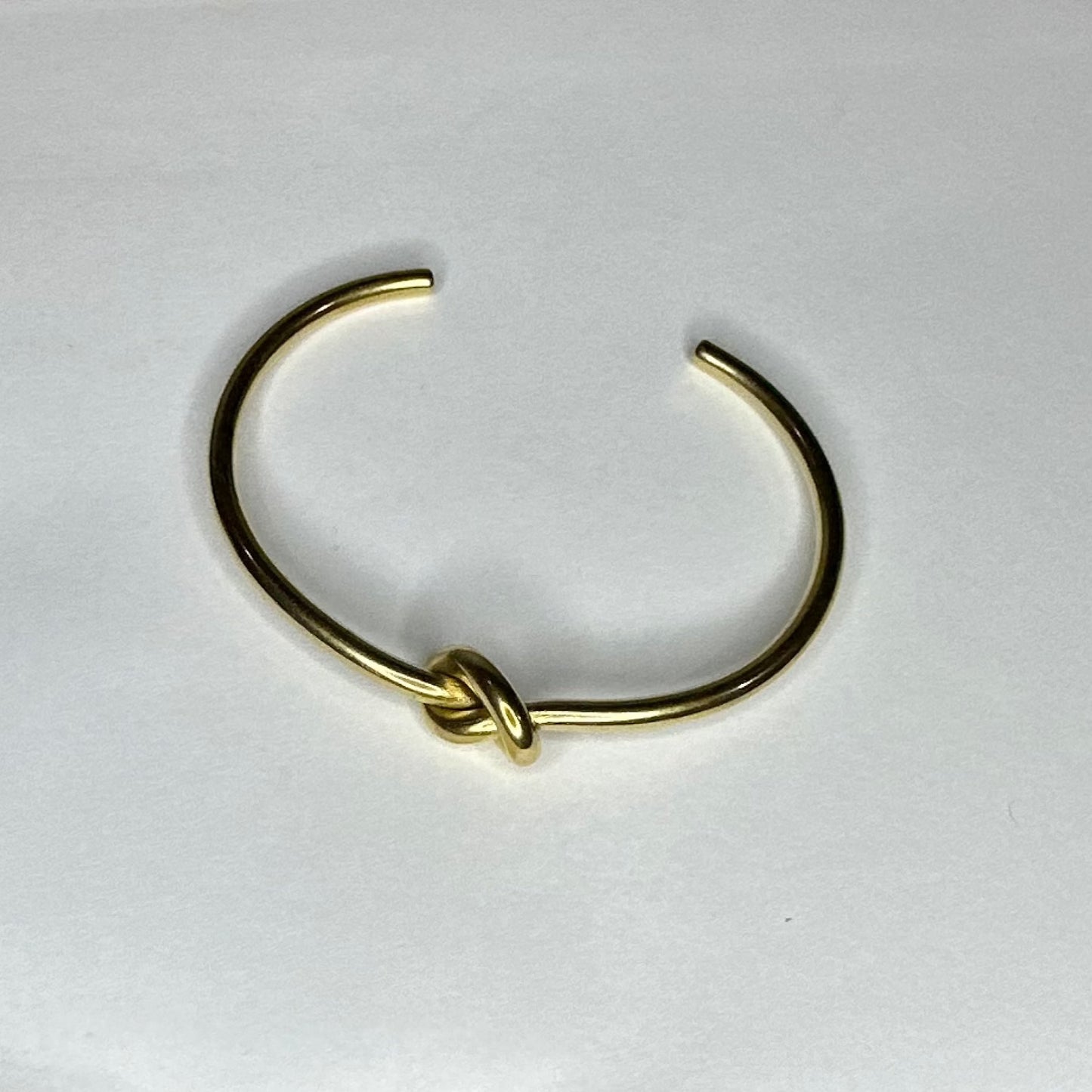 Love Knot Bracelet - Our Love Knot is Crafted Stainless Steel with 18K Gold Overlay Non-Tarnish C-shaped Opening.